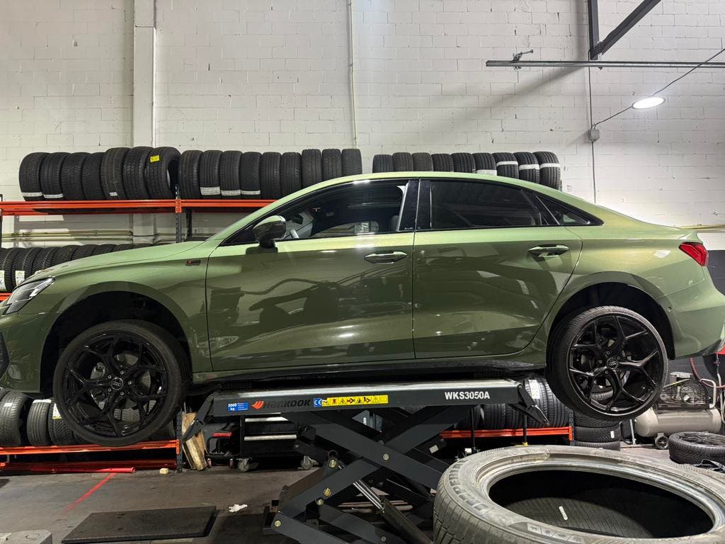 Een groene Audi op de schaarbrug
